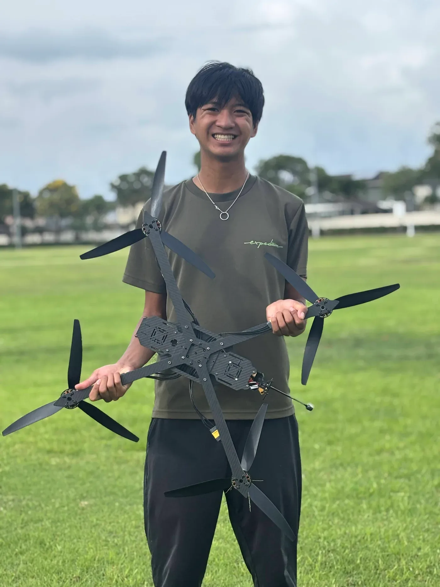 AJ Santa Cruz holding a carbon-fiber drone he built