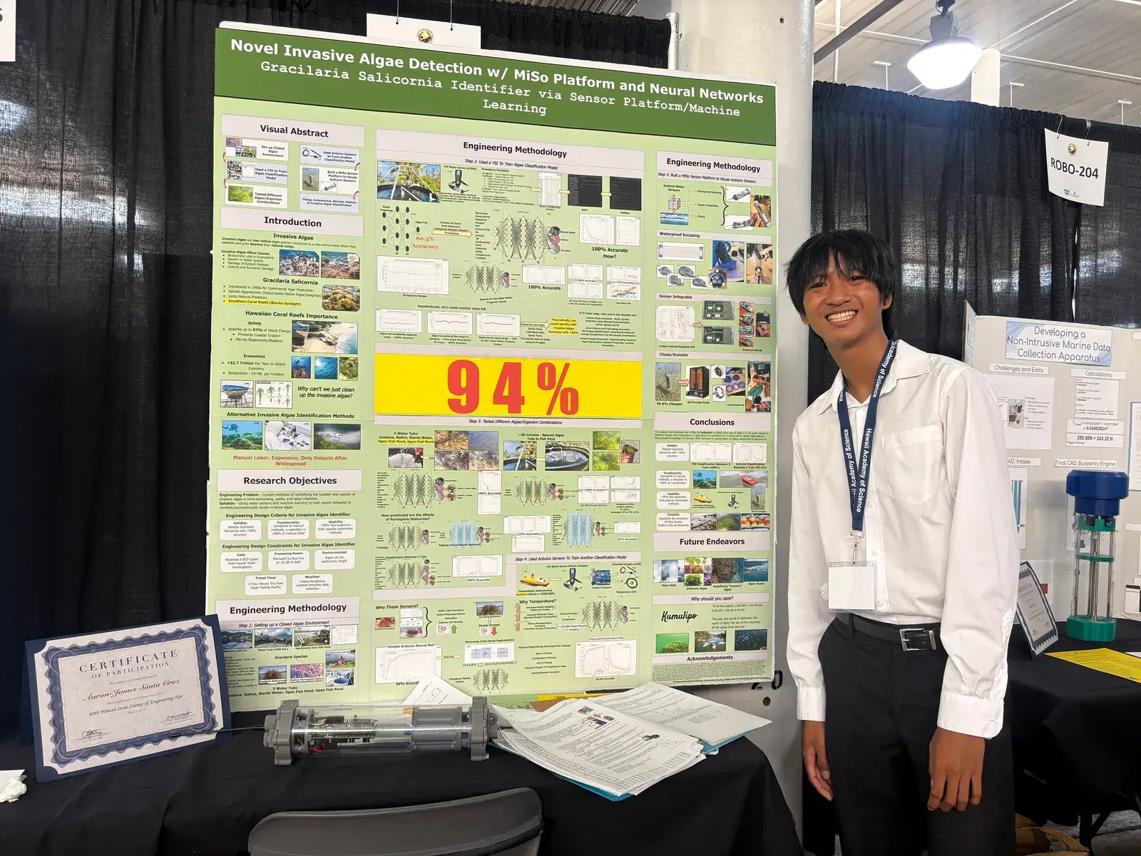 AJ beside the project's research poster at a science fair