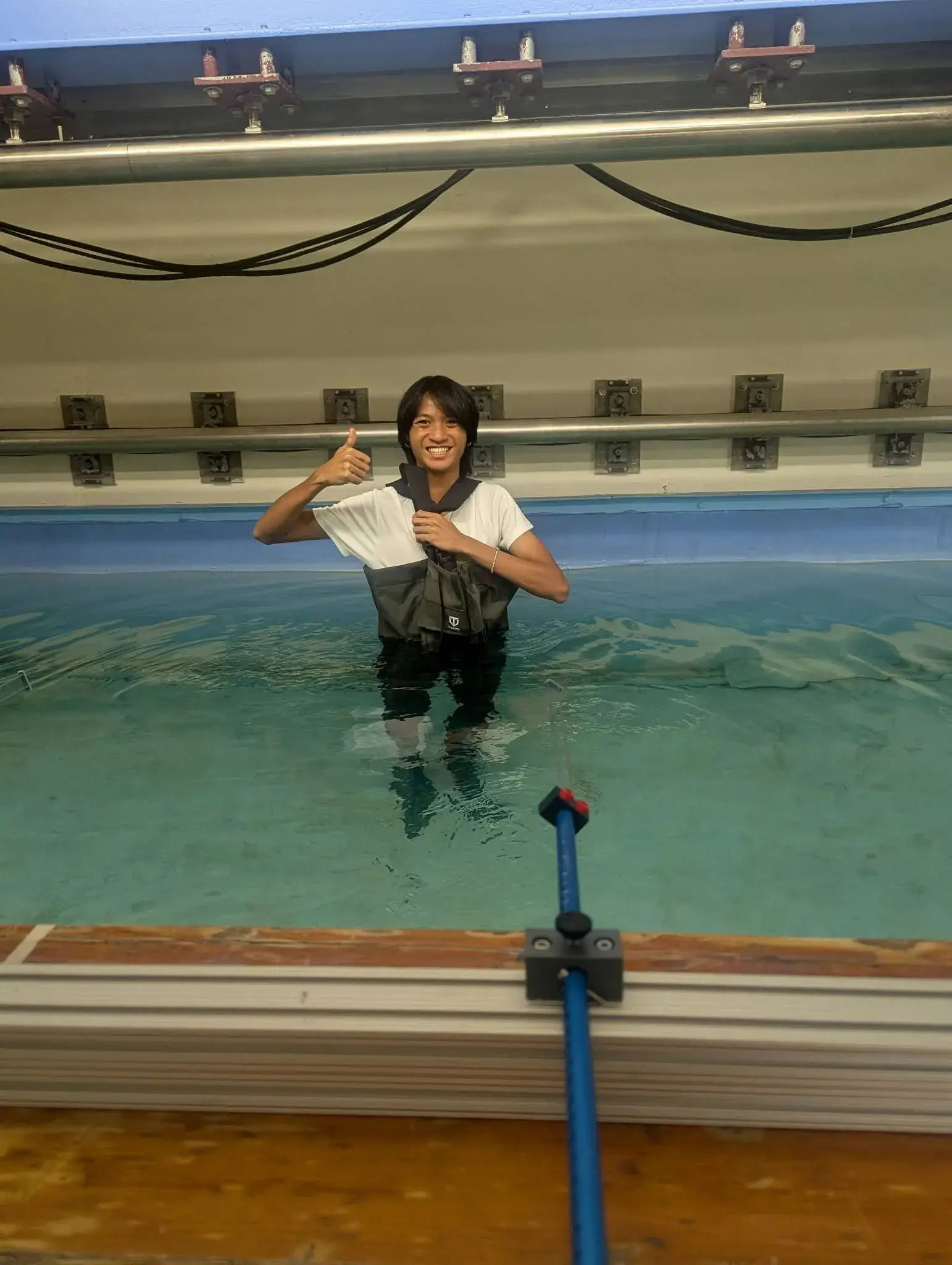 AJ standing in the tow tank holding a hull module