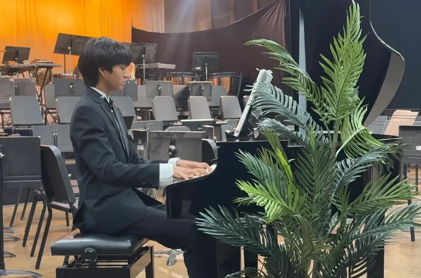 AJ at the piano on a concert stage