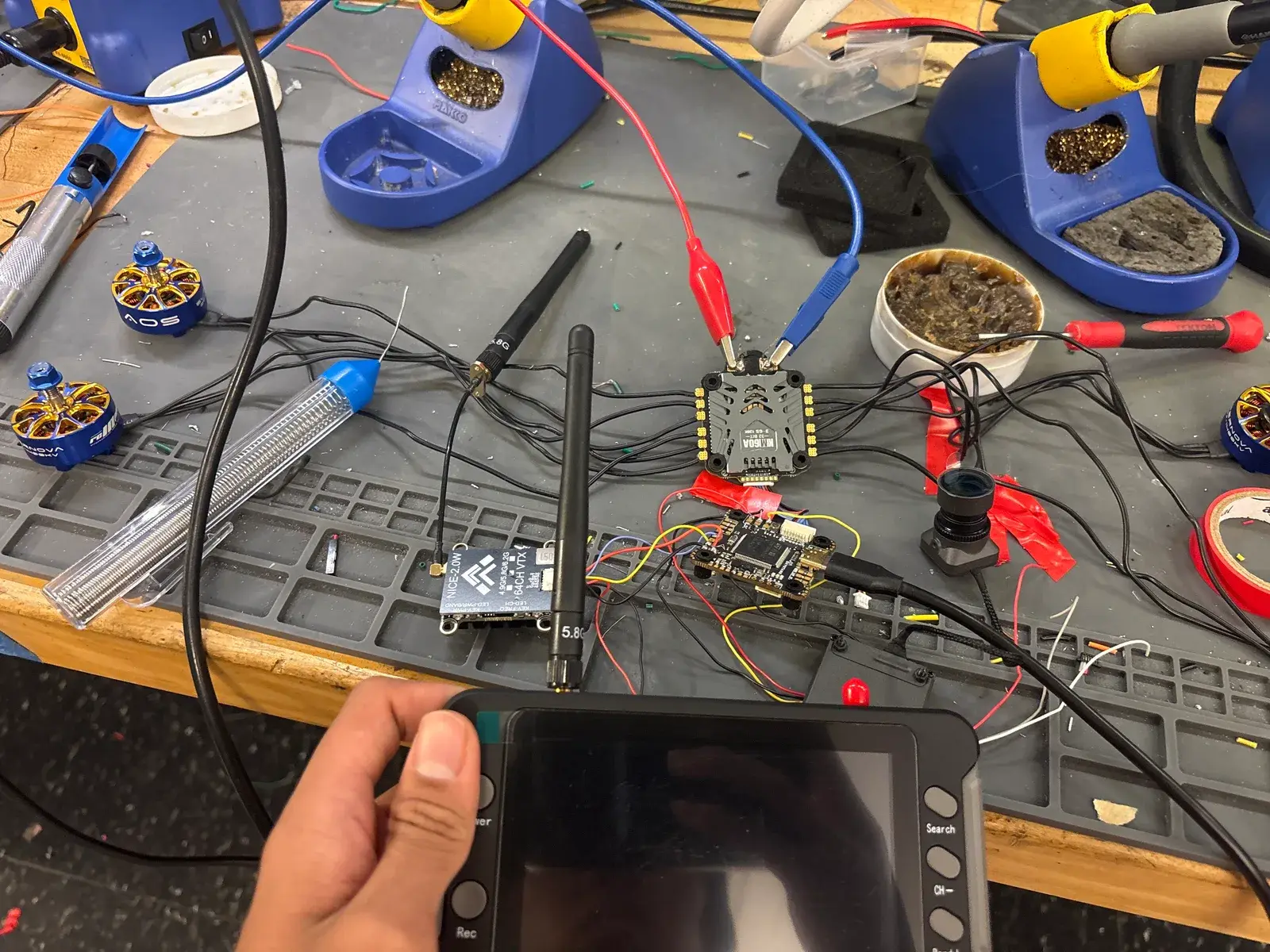 Flight controller, receiver and video wiring laid out on the bench during assembly