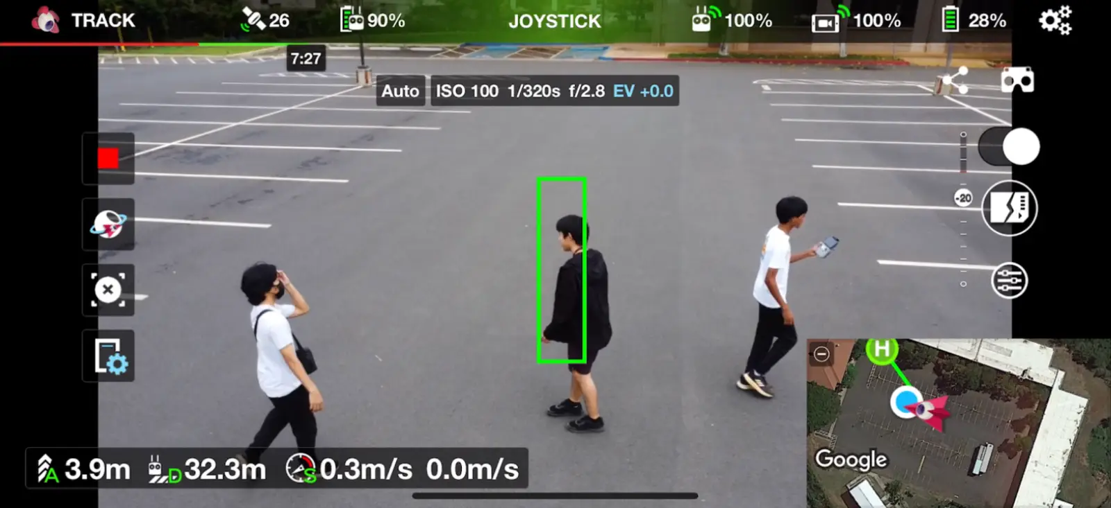 Drone tracking a person on the ground with a bounding-box overlay
