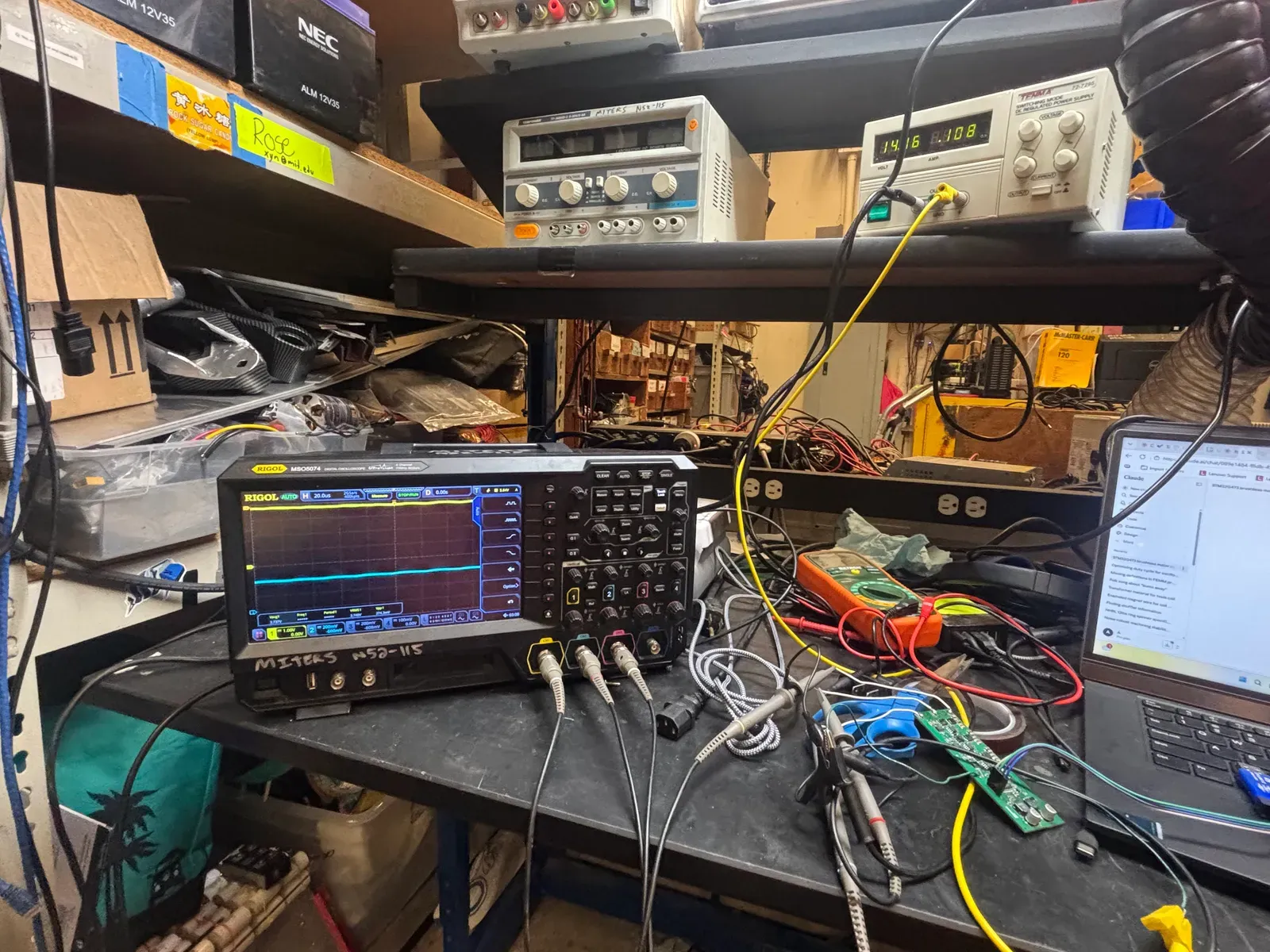 The bench setup with power supply, oscilloscope and laptop