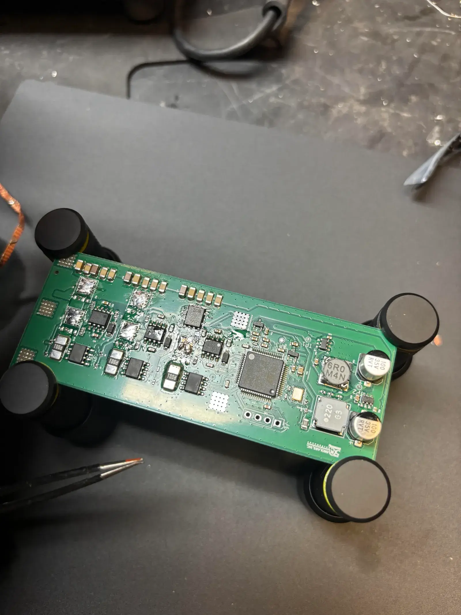 The populated board on test standoffs, STM32 and buck inductors in view
