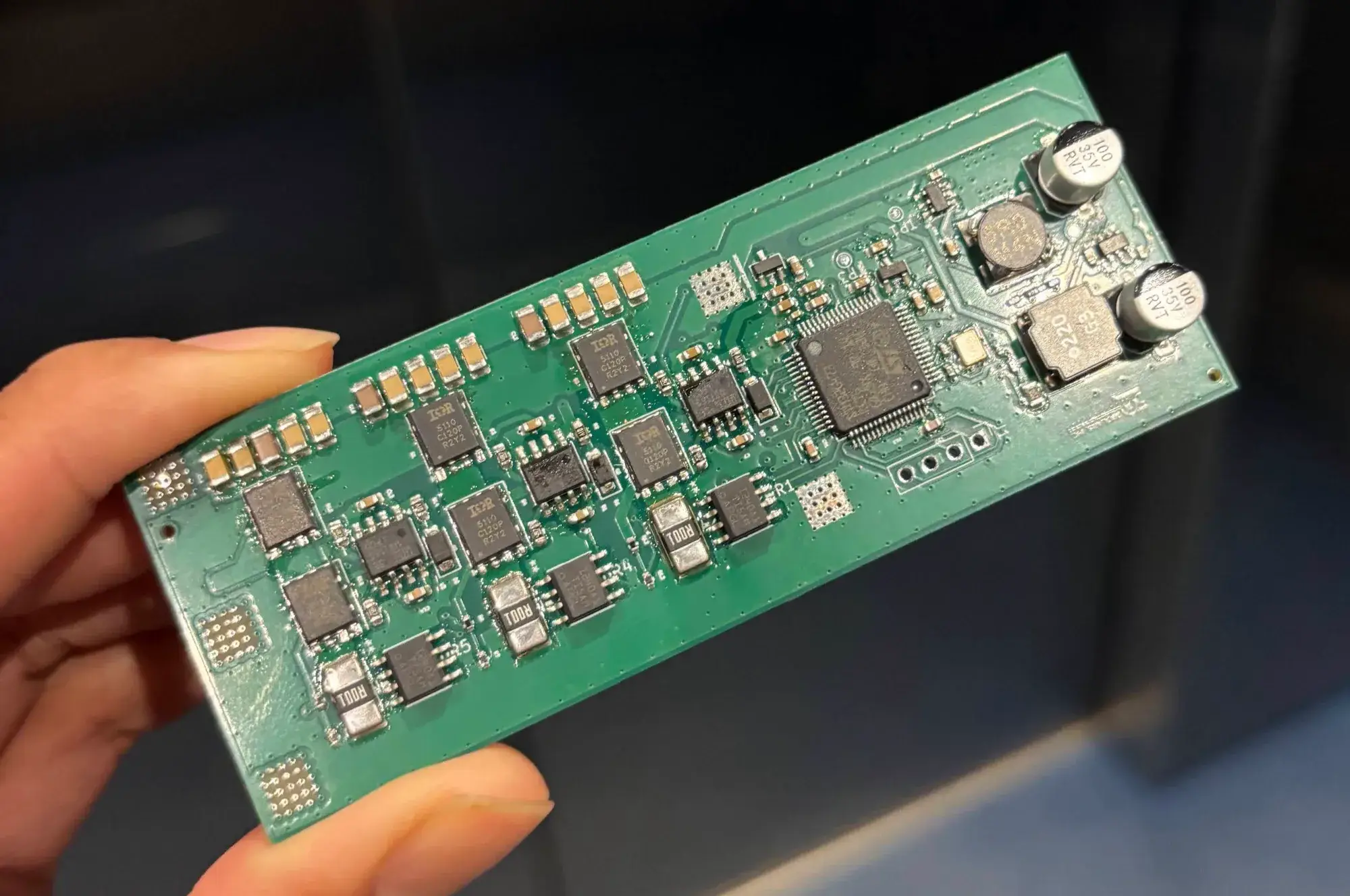 The assembled four-layer 6S motor-controller board held in hand, component side up