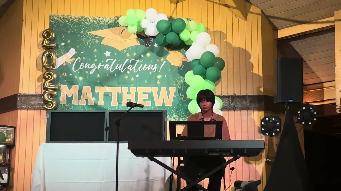 AJ at the keyboard at a graduation party