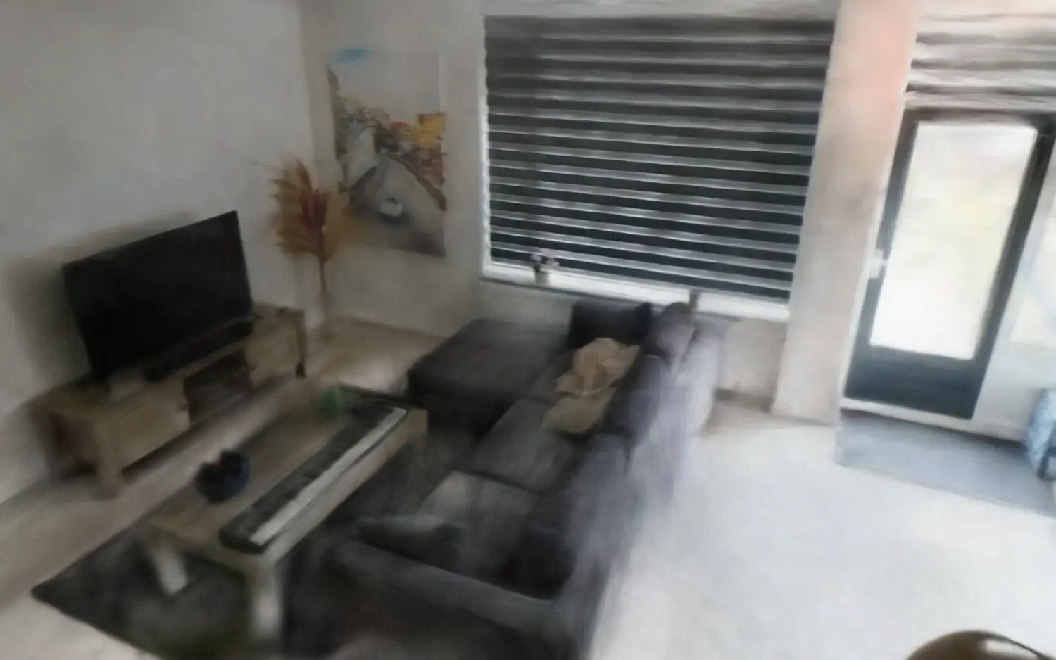 The reconstructed living room, rendered live in the browser from about 556,000 Gaussians