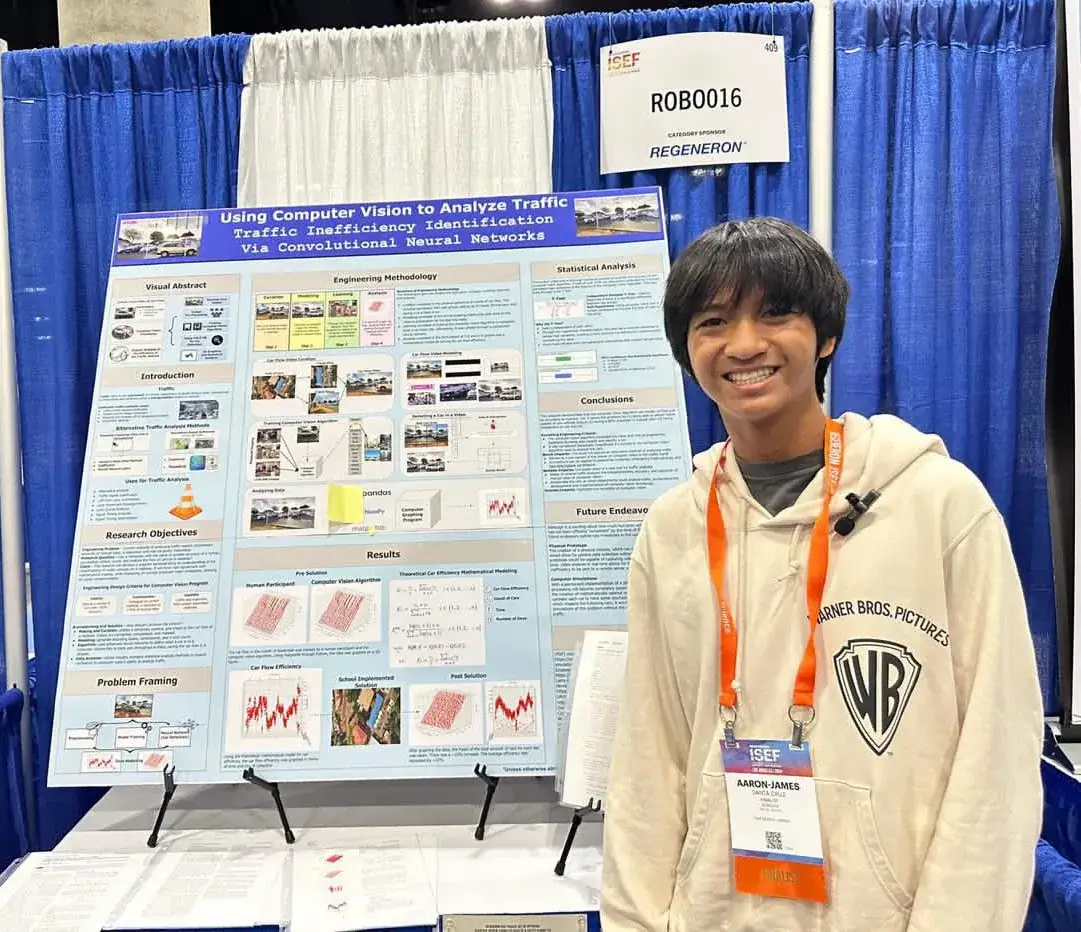 AJ beside the project poster at ISEF